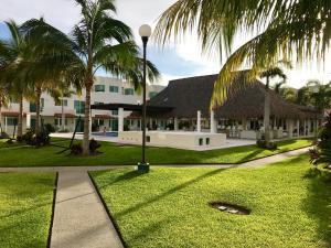 a resort with palm trees and a pathway at Villas Velato in Acapulco