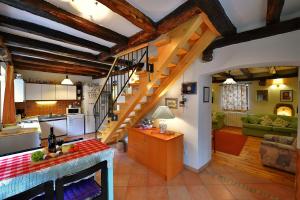 a kitchen and a living room with a staircase at Holiday Home Lori in Paz