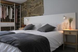a bedroom with two white beds at A Finquiña in Pontevedra