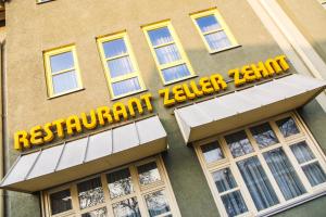 a sign on the side of a building with windows at Hotel Zeller Zehnt in Esslingen