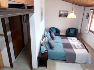 a bedroom with a bed with blue pillows at Finca Gamundi in L'Ampolla +34 photos