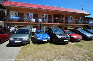 a group of cars parked in front of a building at Pelikan II in Rowy