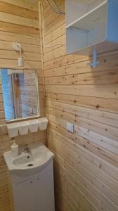 a bathroom with a sink and a mirror at Pajūrio brizas in Šventoji +43 photos