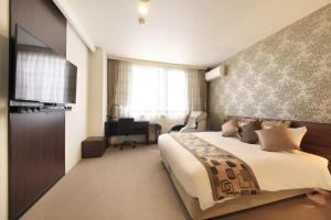 Postel nebo postele na pokoji v ubytování Hotel Tohkai