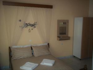 Postel nebo postele na pokoji v ubytování En Leuko Apartments