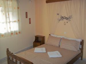 Postel nebo postele na pokoji v ubytování En Leuko Apartments