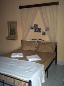 Postel nebo postele na pokoji v ubytování En Leuko Apartments