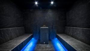 a bathroom with a bath tub with blue lights at Hotel Andreas Hofer in Brunico