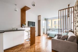 a living room with a couch and a tv at Central Station Apartment - Wilcza in Warsaw