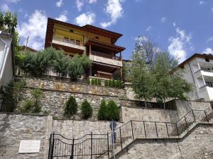 um edifício no topo de uma parede de pedra com escadas em "Вила Баните" em Banite