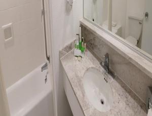 a bathroom with a sink and a mirror at Mision Mazatlan in Mazatlán