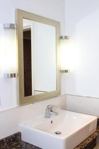 a bathroom with a white sink and a mirror at Humber Royal Hotel in Grimsby