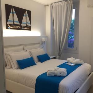 a bedroom with a bed with towels on it at Residenza Elisa in Desenzano del Garda