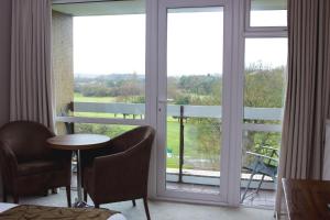 a room with a large window with a table and chairs at Humber Royal Hotel in Grimsby