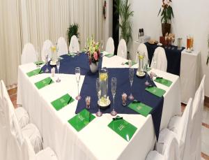 a room filled with tables and chairs filled with wine glasses at Mision Mazatlan in Mazatlán
