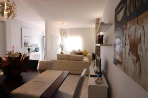 a living room with a couch and a table at APARTAMENTO MICÁ in Albufeira