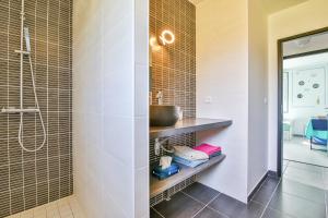 a bathroom with a sink and a shower at Villa d'Eau Douce in La Mothe-Achard +44 photos