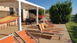 a group of chairs and hammocks on a patio at Villa Polercia in Cupello