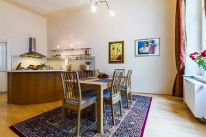 a kitchen and dining room with a table and chairs at Apartment Victor in Prague