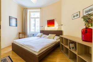 a bedroom with a bed and a window at Apartment Victor in Prague