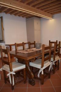 a wooden dining room table with chairs and a vase on it at Holiday and Art 2 in Pisa