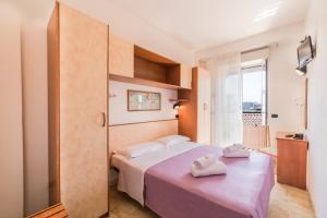 Postel nebo postele na pokoji v ubytování Hotel Garisenda