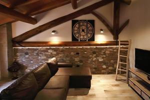 a living room with a couch and a clock on the wall at LA MAESTA' in Langhirano +17 photos