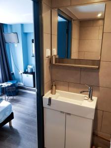 a bathroom with a white sink and a mirror at Urban Vibes Guesthouse in Amsterdam