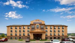 a large building with a sign on top of it at Baymont Inn & Suites by Wyndham Sturgis in Sturgis