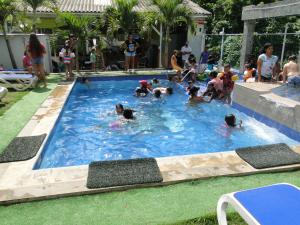 a group of people in a swimming pool at Casa Loft in San Andrés