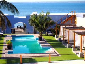 a swimming pool with the ocean in the background at Feitoria Boutique Hotel in Ilha de Moçambique