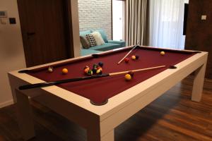 a pool table with balls on it in a living room at Apartmán 17 Romantika Chopok Juh Tále in Tale