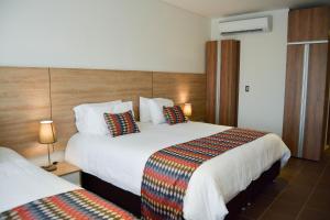 Ένα ή περισσότερα κρεβάτια σε δωμάτιο στο Alko Hotel Integrado