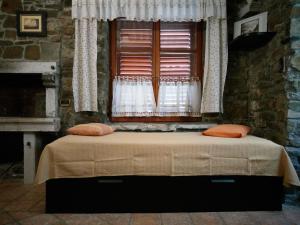 a bedroom with a bed in front of a window at Apartments Old Isola in the center in Izola