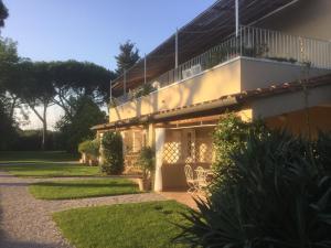 a house with a balcony on the side of it at Relais Le Fornacelle in Castagneto Carducci