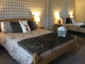 a bedroom with two beds and a basket on a bed at Tigh Na Mara in Furnace