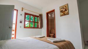 Postel nebo postele na pokoji v ubytování Hotel el Manglar