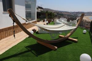 a hammock on a balcony of a house at B&B Vista sul Mare in Porto Empedocle