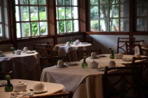 a dining room with tables with white table linens at Hotel Geronimo in Pucón +70 photos