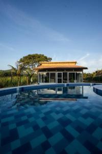 a villa with a swimming pool in front of a house at Indigo Palomino in Palomino