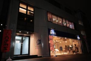 a building on a city street at night at Mezame Hostel in Nagasaki