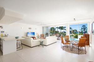 a living room with a couch and a table at Allambi Apartment 2, 25 Allambi Rise, Little Cove in Noosa Heads