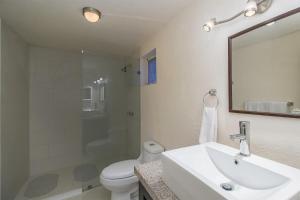 a bathroom with a sink and a toilet and a mirror at Pied à Terre at Casitas Aparicio in San Miguel de Allende