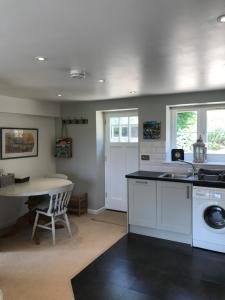 a kitchen with a sink and a table at Crosspark in Kingsbridge