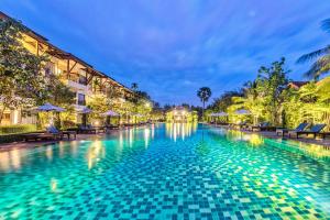 a swimming pool at a resort at night at Angkor Palace Suite & Villa in Siem Reap