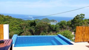 a swimming pool with a view of the ocean at Karo Villas in Ko Tao