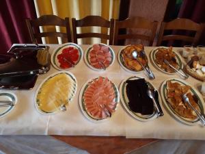 a table with many plates of food on it at Sintrivanis Mountain in Áno Skotína