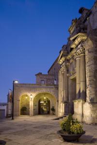 
a large stone building with a clock on it at Parador de Plasencia in Plasencia
