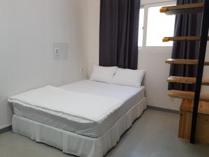 a bed in a room with a window at Maison de Geoje in Geoje 