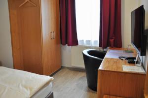 TV a/nebo společenská místnost v ubytování Garni Hotel Alber